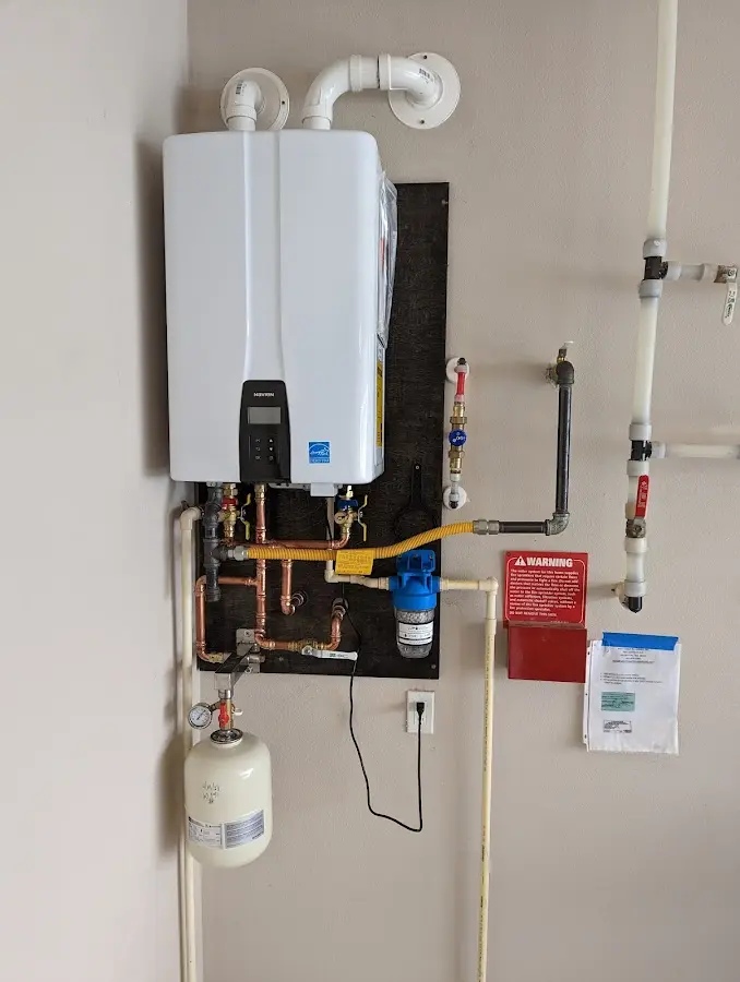 Professional plumber installing copper piping in a Clay home